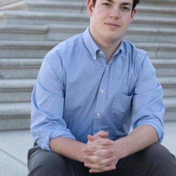 Portrait of Henry Marks sitting on steps outdoors 