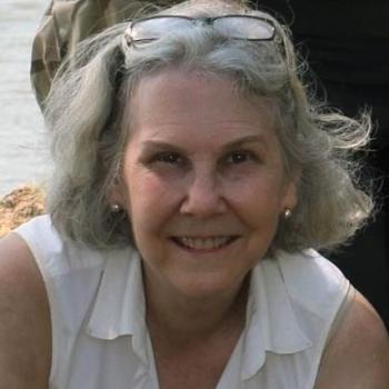 Julia King looks up from an archaeological site