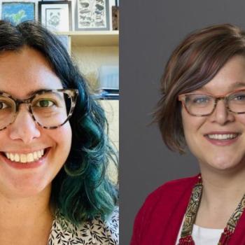 Two women with glasses smiling; the woman on the left has wavy dark hair with green tips, and the woman on the right has short brown hair and wears a red cardigan.