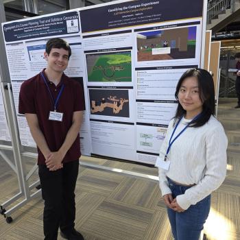 Sophia Lin (COSC 2026) and Joshua D. Swanson (COSC 2026)  stand in front of their poster at the conference.